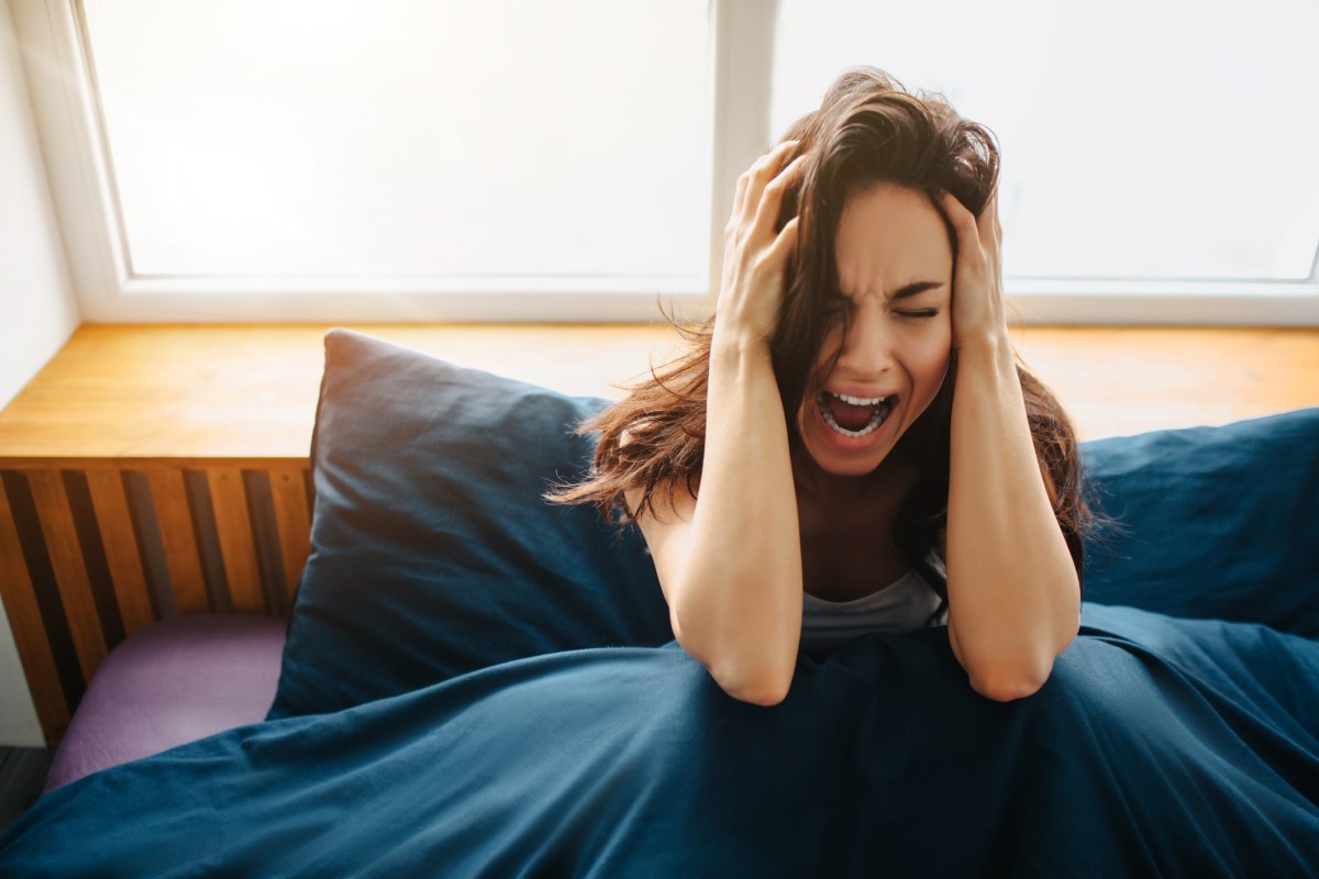 Vrouw met ernstige hoofdpijn - een symptoom van een bloeding in de hersenen